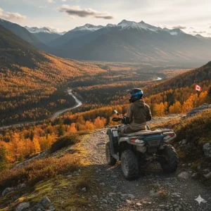 A rider wearing a high-quality ATV helmet in Canada, overlooking a scenic mountain trail in British Columbia during autumn.