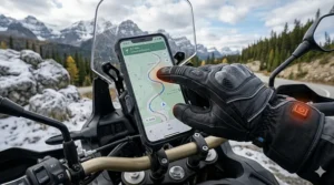 Rider using a smartphone GPS with touchscreen-sensitive heated motorcycle gloves while touring Canada.