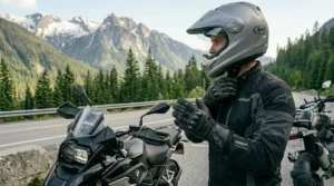 A rider inspecting the high-quality stitching and durable fabric of textile motorcycle gloves before a cross-Canada trip.