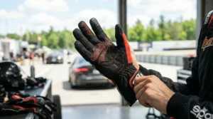 Detailed view of the palm side of track day gloves showing high-grip textures and ergonomic stitching for better steering control.