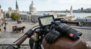 Close-up of touchscreen-compatible leather motorcycle gloves being used to navigate a GPS map of Montreal streets.
