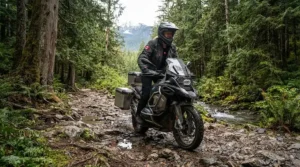 Adventure motorcyclist navigating British Columbia backcountry trails while staying warm with a durable heated undershirt for motorcycle riding.