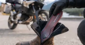 Moisture-wicking fabric demonstration on heated socks keeping feet dry during long-distance autumn motorcycle trips across Canada.
