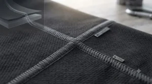 Extended sleeve cuff with a secure thumbloop on a synthetic thermal base layer for motorcycle riding, preventing sleeve bunching inside riding gloves.