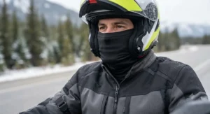 Motorcycle rider wearing a multi-season neck gaiter tucked into a jacket to prevent wind chill.