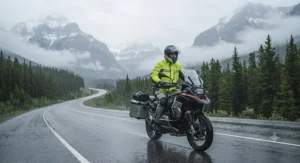 Motorcyclist staying dry in packable rain gear while touring through the scenic Canadian Rockies.