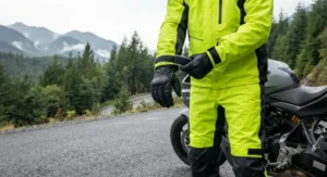 Detailed view of fully taped seams and storm flaps on a waterproof rain jacket and pants set for motorcyclists to prevent water leakage in freezing rain.