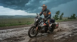 A two-piece waterproof rain jacket and pants set for motorcyclists highlighting adjustable velcro cuffs and secure boot stirrups for high-speed riding.