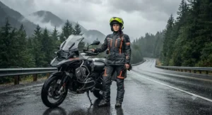A woman wearing a durable womens motorcycle rain suit standing next to her touring bike on a wet highway.