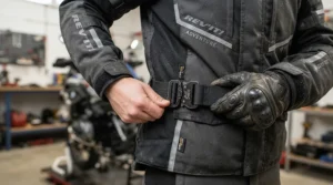Close-up of a curve-friendly waist adjustment on a women's motorcycle rain suit designed for a secure, custom fit.